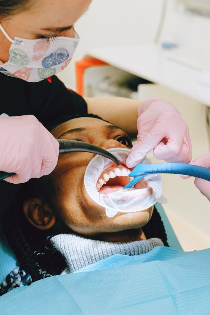 Close-up of a dental professional performing a checkup on a patient in a clinic setting.