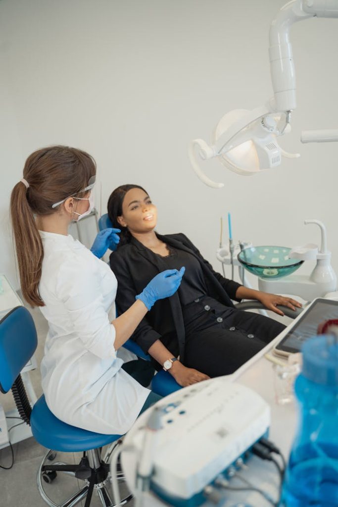 Dentist treats patient at a dental clinic using advanced equipment. Healthcare setting.